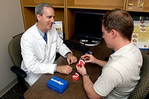 Dr. Robert Schmidt showing patient invisalign.