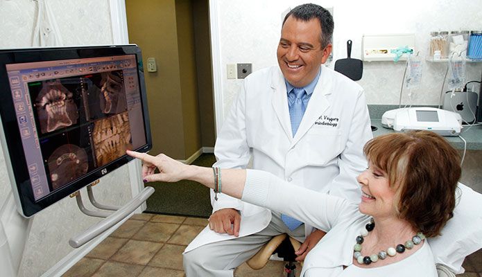 Dr. Robert Vazquez next to x-ray machine.